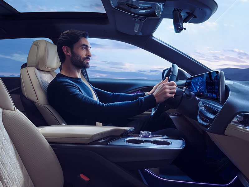 Passenger Seat View of a Man Driving the Cadillac OPTIQ Electric SUV