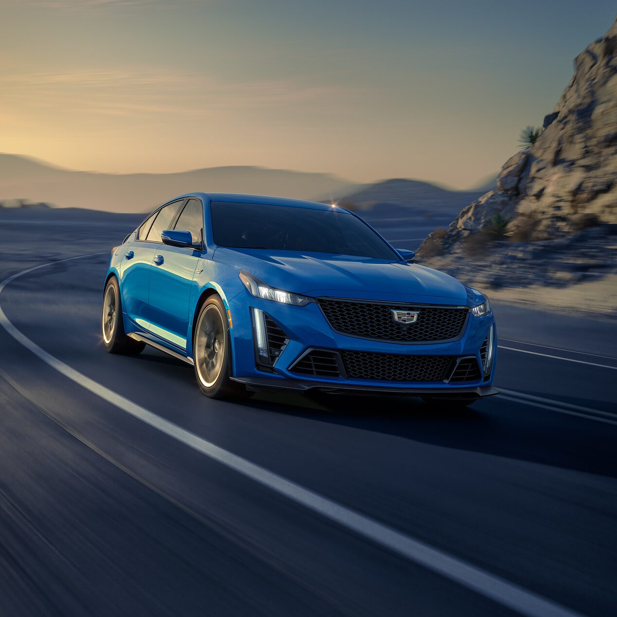 The CT5-V Cruising on an Open Mountain Road During the Sunrise