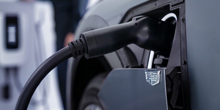 Close Up of a Charger Plugged Into the Charging Port on a Cadillac Electric Vehicle