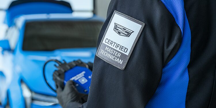 Closeup of a Cadillac Certified Service Technician's "Certified Master Technician" Badge on Their Shirt Sleeve