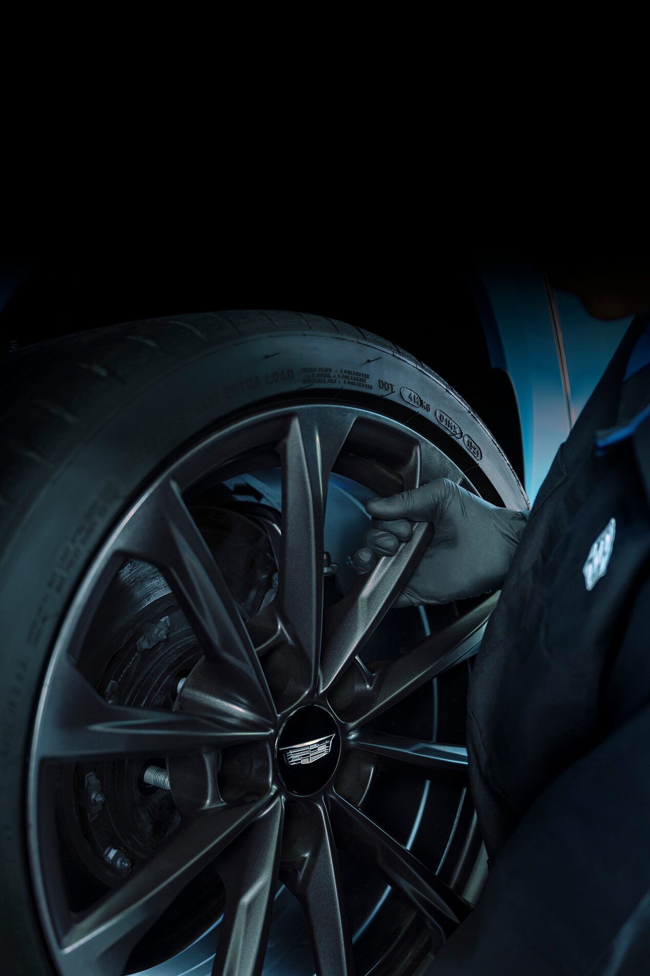 Cadillac Certified Service Technician Installing a New Wheel on a Vehicle