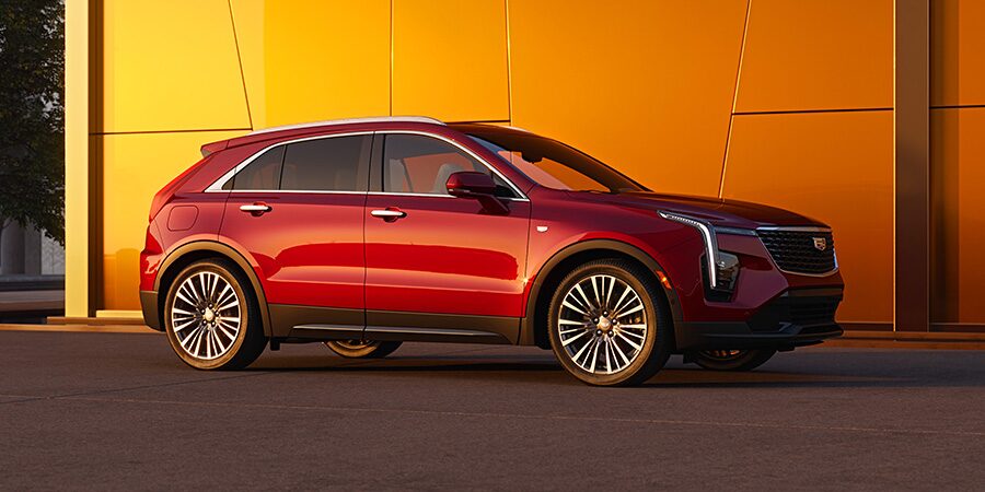 Side View of a Red Cadillac SUV Parked on the Side of the Road