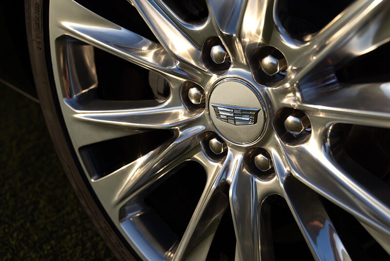 Close-up of a Cadillac Tire with the Steel Emblem at the Center of the Wheel