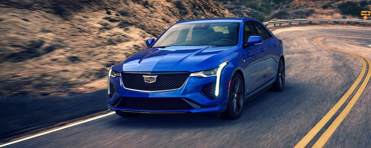 Front View of a Blue CT4 Driving Through a Curvy Mountain Road