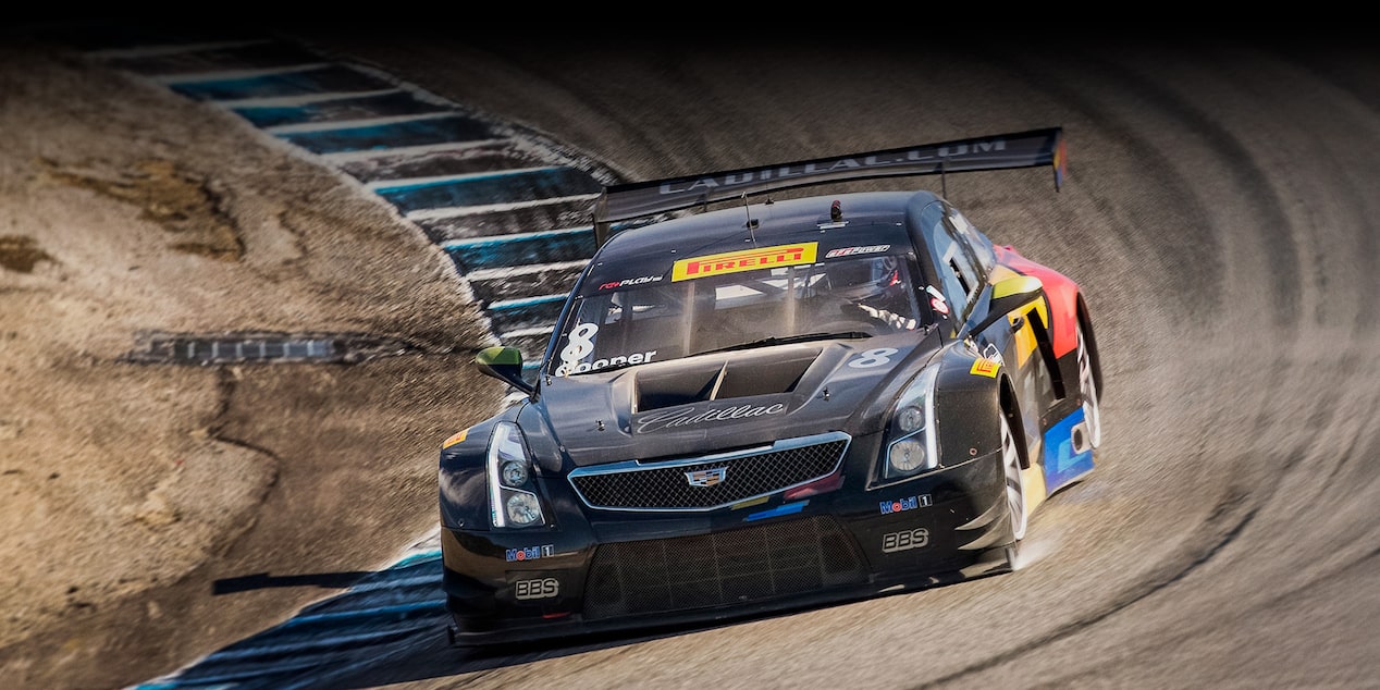 The Cadillac Racing ATS-V.R Heritage Race Car Fiercely Driving on the Curve of a Track