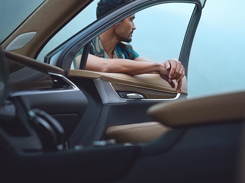 A Man Leans on the Open Passenger Window of His Cadillac XT6
