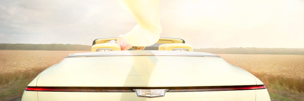 Rear View of a Woman with a Flowing Scarf Driving the Cadillac Sollei Concept Convertible