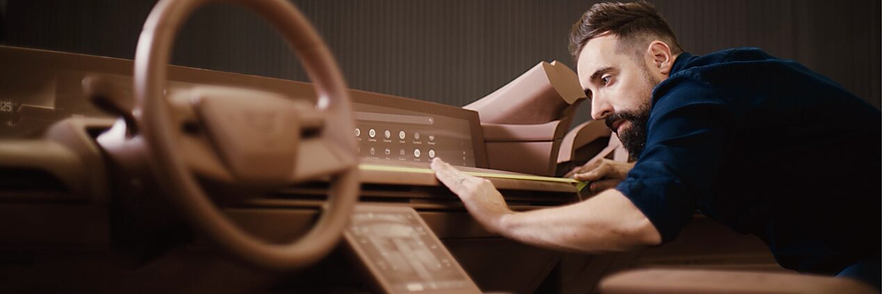Man Carving Vehicle Interior Out Of Clay