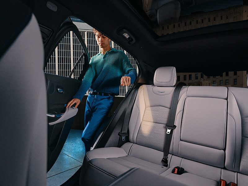 A Man Opening Door to Enter the 2025 Cadillac XT4 Spacious Rear Seat