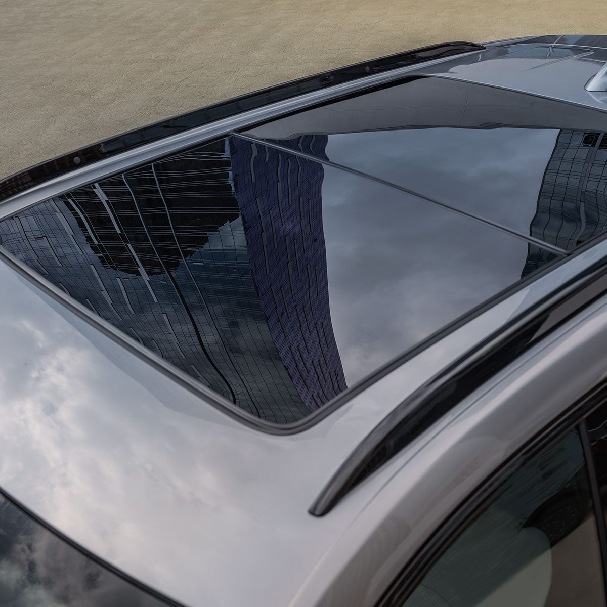 The Massive Sunroof of the 2025 Cadillac XT4 Reflecting the Clouds in the Sky