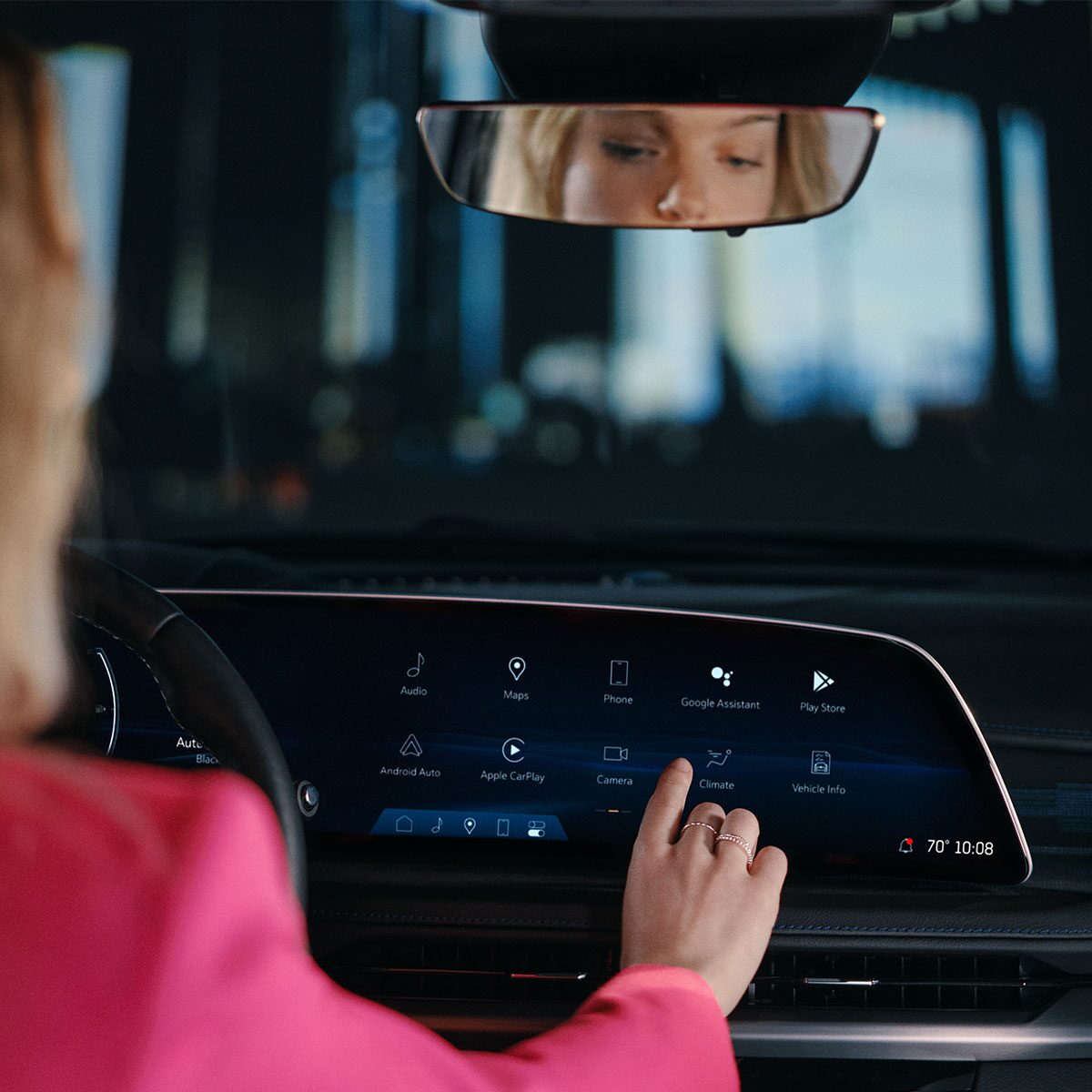 A Woman Utilizing the 2025 Cadillac XT5 Infotainment System Touch Screen