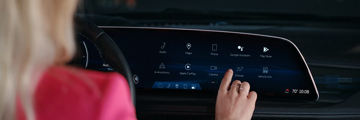 A Woman Utilizing the 2025 Cadillac XT5 Infotainment System Touch Screen