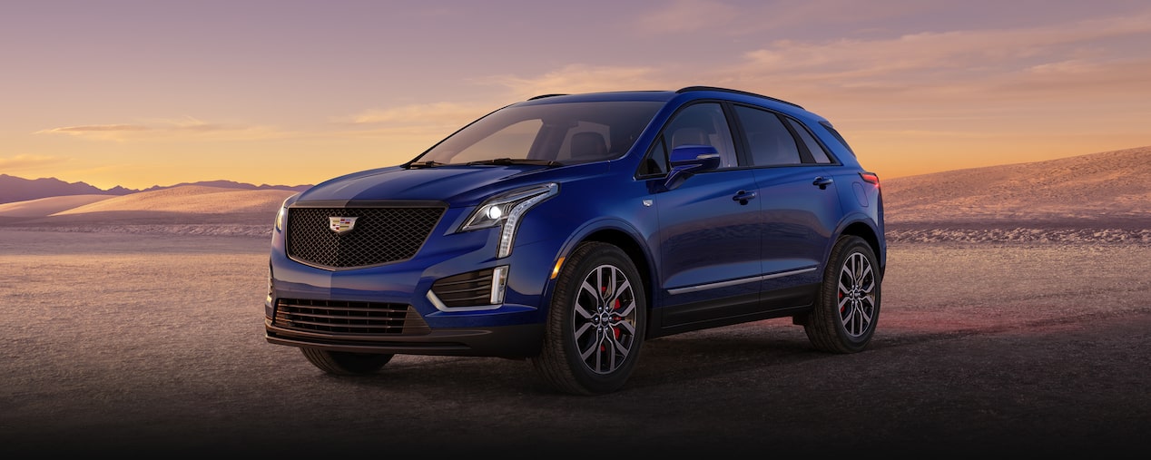 The Dark Moon Blue Metallic Cadillac XT5 Parked During the Sunset in Desert
