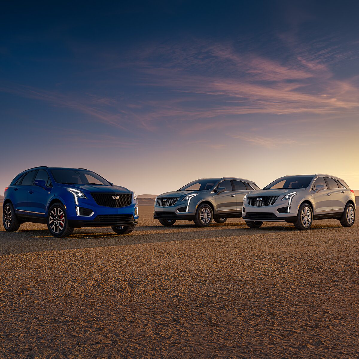 Three 2025 Cadillac XT5 Vehicles Parked During the Sunset in the Desert