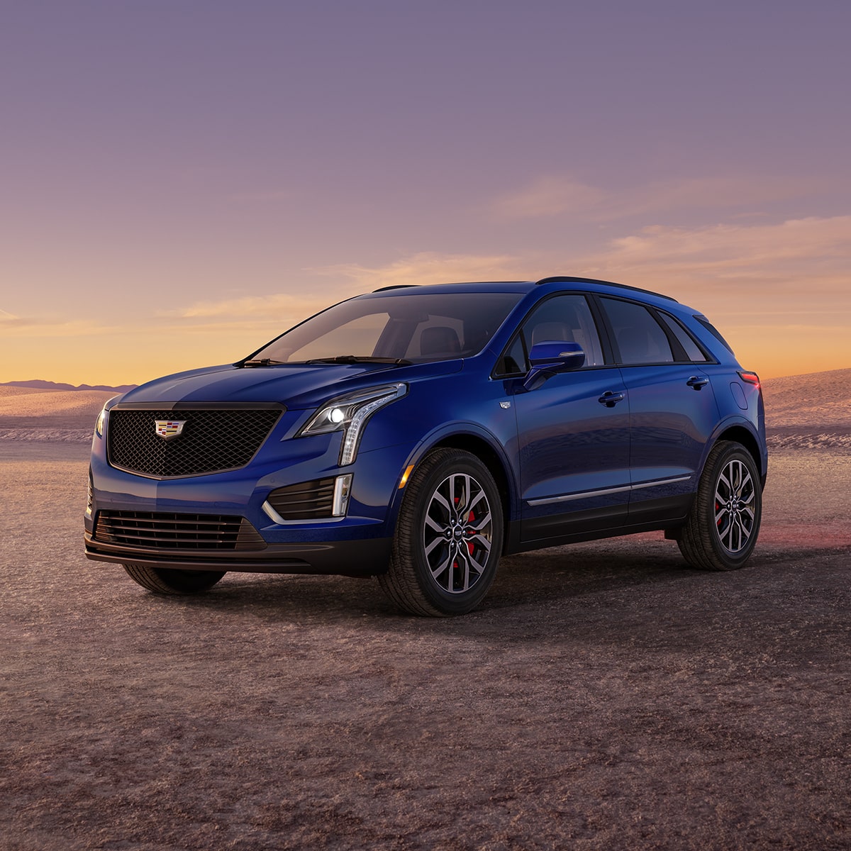 The Dark Moon Blue Metallic Cadillac XT5 Parked During the Sunset in Desert