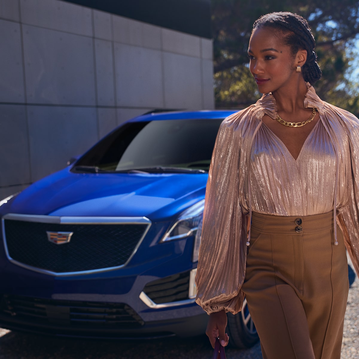 A Fashionable Dressed Woman Walking Away From Her Parked 2025 Cadillac XT5