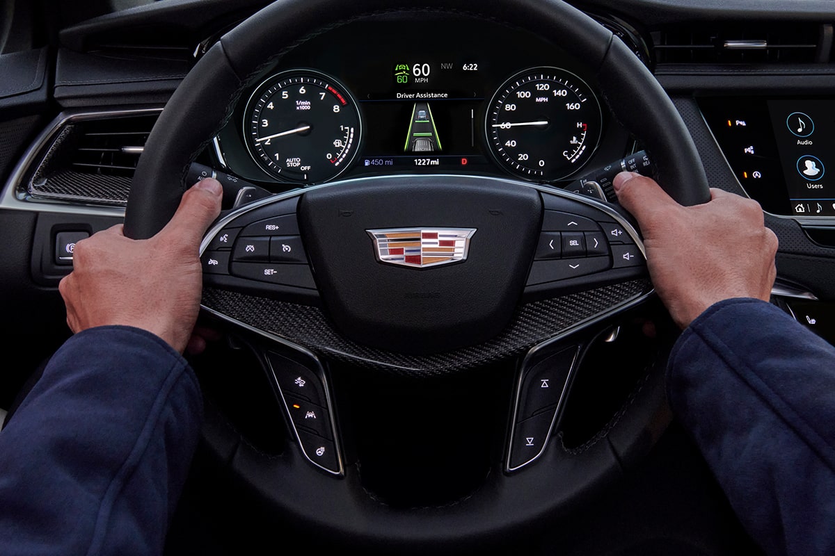 Driver's Hands Gripping the 2025 Cadillac XT5 Steering Wheel