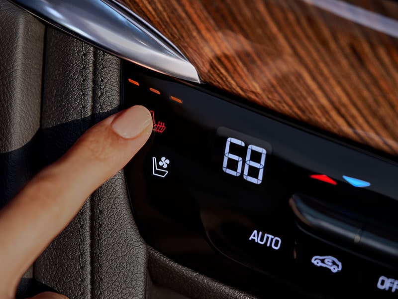 A Person Choosing Heated Rear Seats Function Inside the New Cadillac XT6