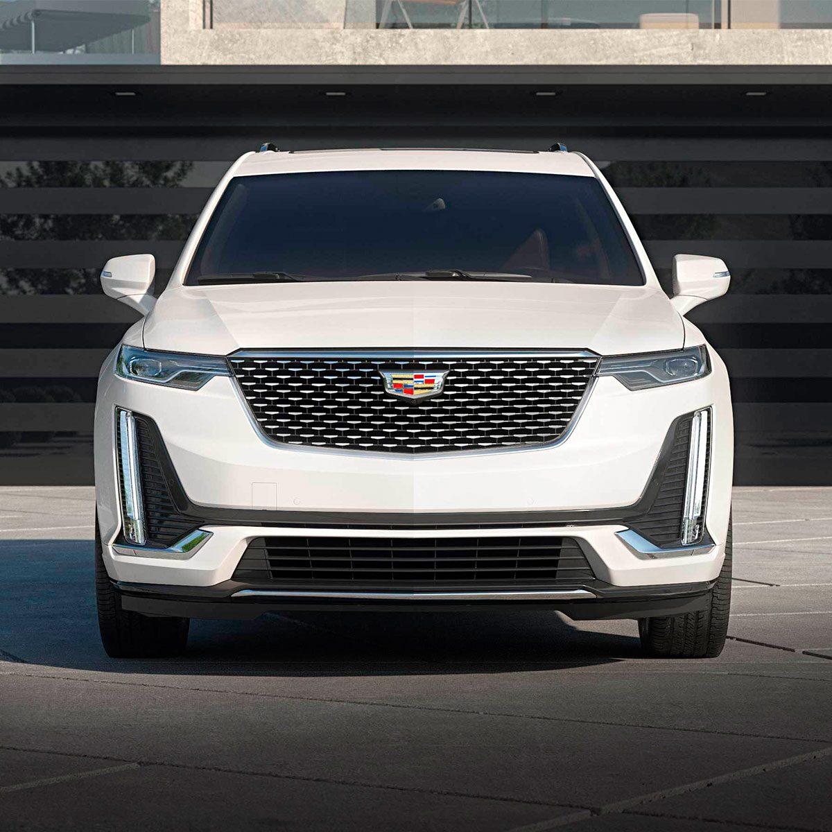 The Crystal White Tricoat Cadillac XT6 Parked in a Driveway