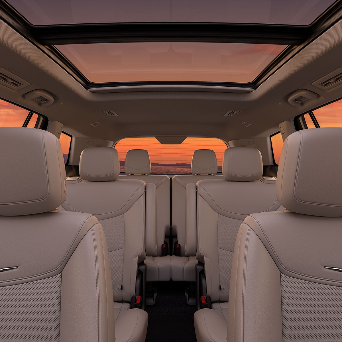 Three Rows of Tan Leather Seats Inside the New Cadillac XT6 Parked Under the Sunset