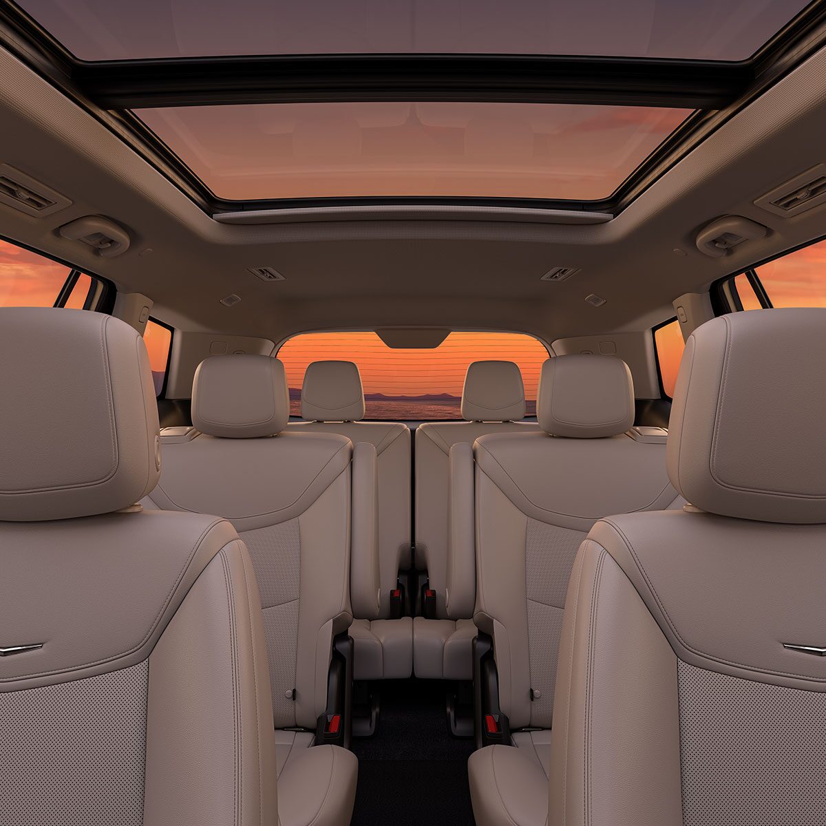 Three Rows of Tan Leather Seats Inside the New Cadillac XT6 Parked Under the Sunset