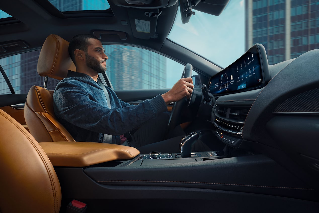 Passenger View of a Man Driving a 2025 Cadillac CT5 Through the City