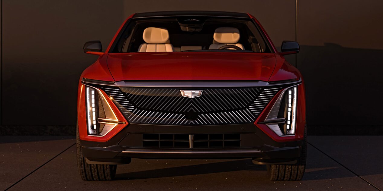 Front View of a Parked Red Cadillac LYRIQ and Close-up on LED Slim Headlights