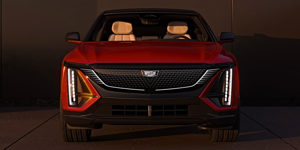 Front View of a Parked Red Cadillac LYRIQ and Close-up on LED Slim Headlights