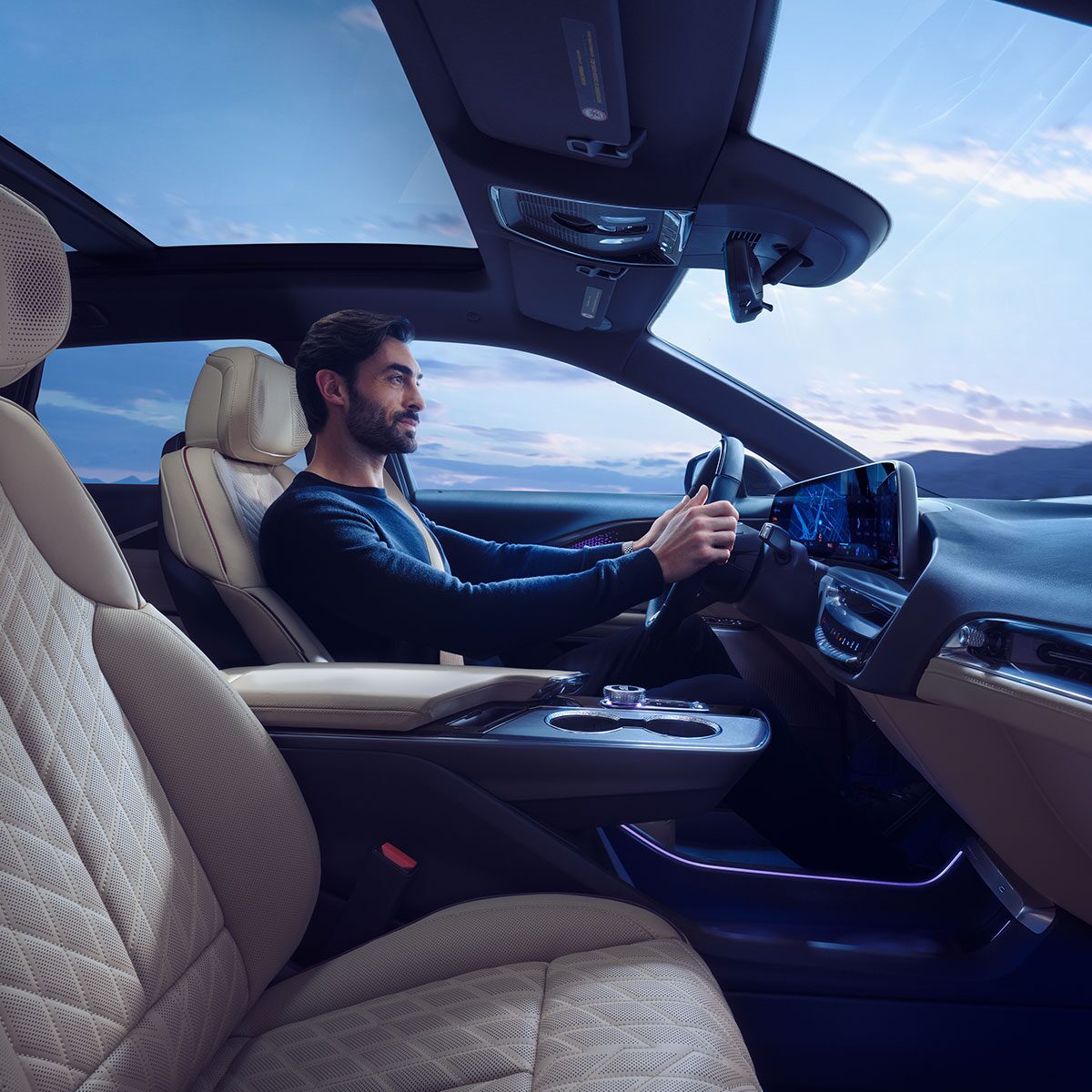 Passenger Seat View of a Man Driving the 2025 Cadillac LYRIQ Using the Navigation System