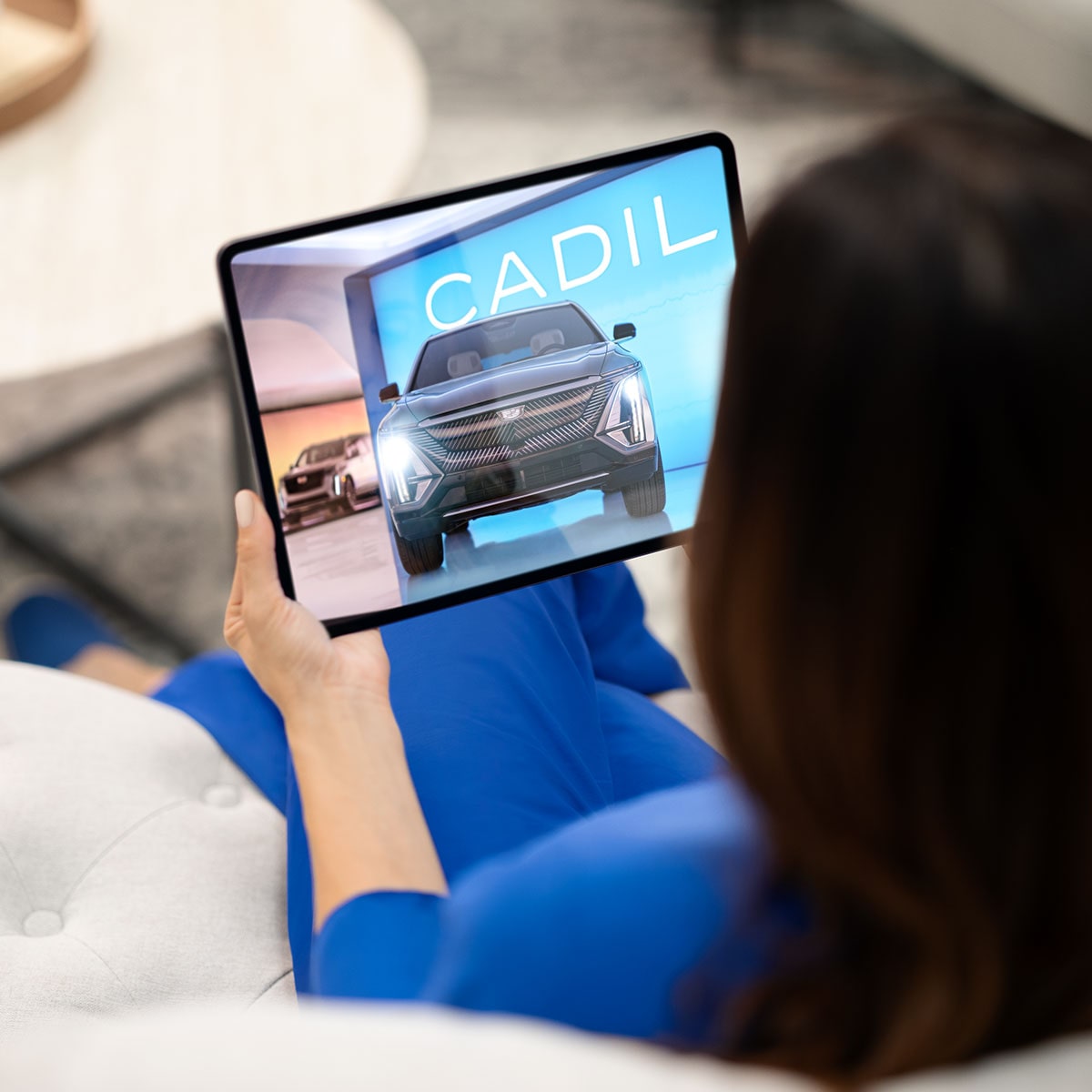 Close-up of a Woman Using a Cadillac App on a Tablet