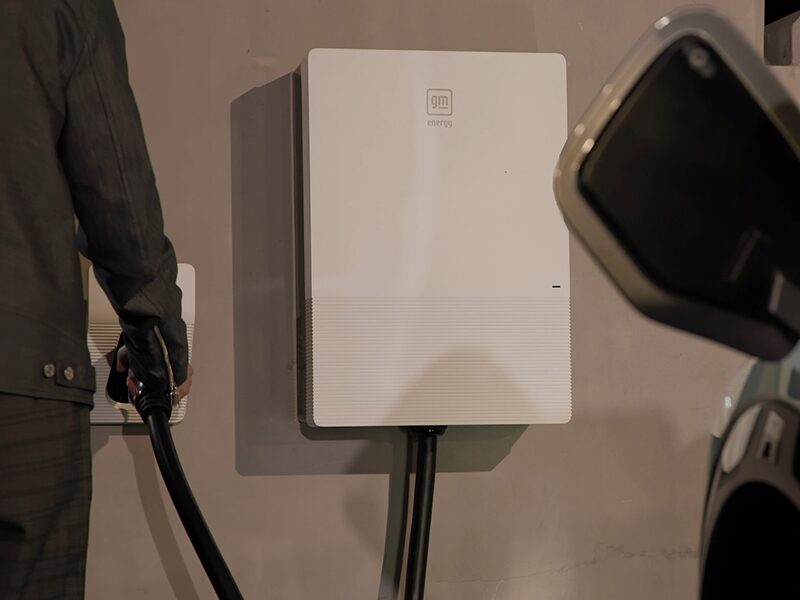 A Man Using the GM Energy Home Charger to Charge a 2025 Cadillac OPTIQ