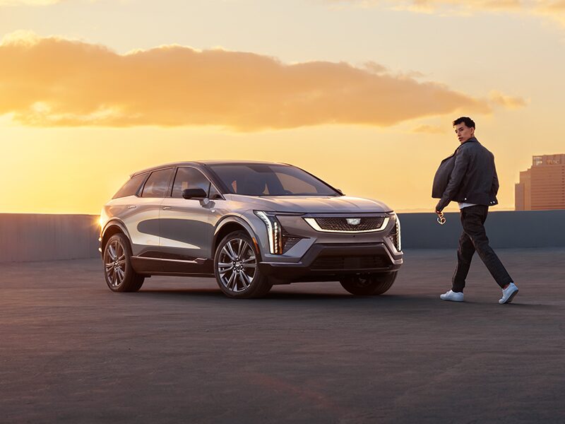 A Man Walking To a 2025 Cadillac OPTIQ During a Beautiful Sunset