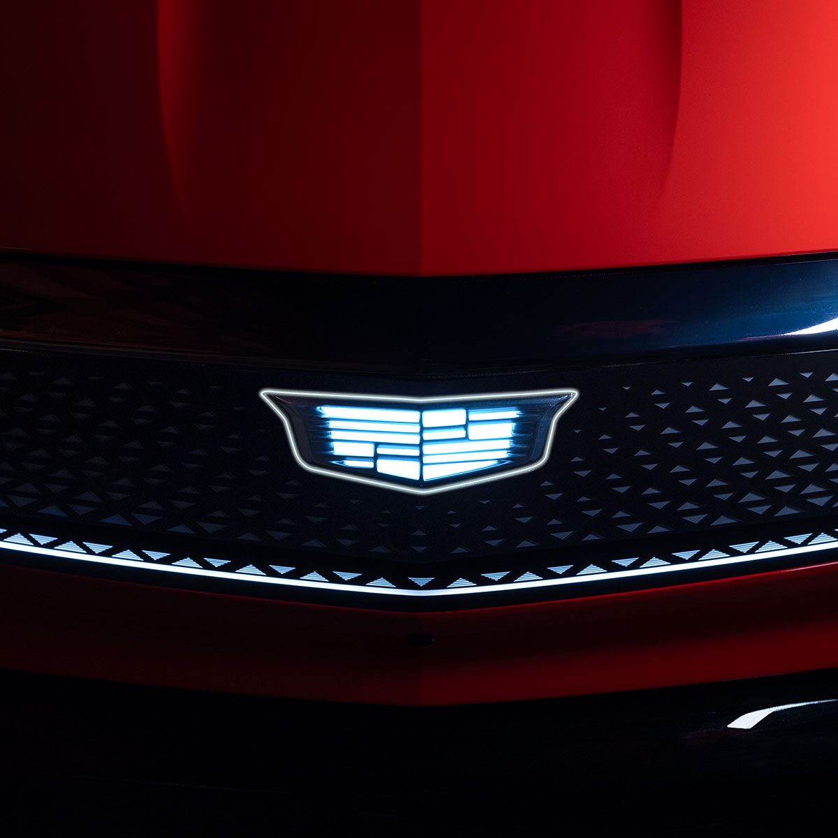 Close-up View of the Illuminated Cadillac Logo on the 2025 OPTIQ Grille