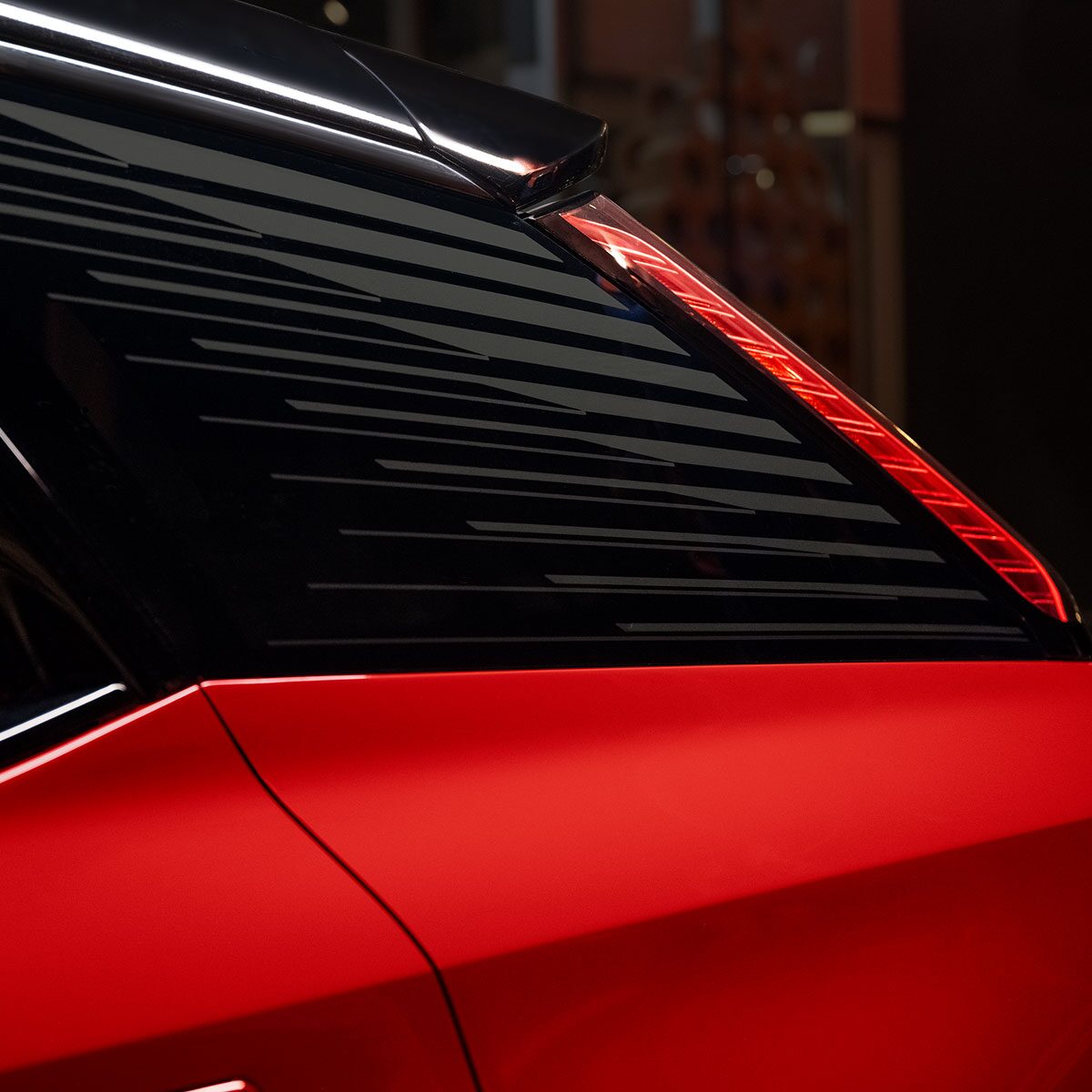 Close-up View of the 2025 Cadillac OPTIQ Rear End Accents and Headlamp