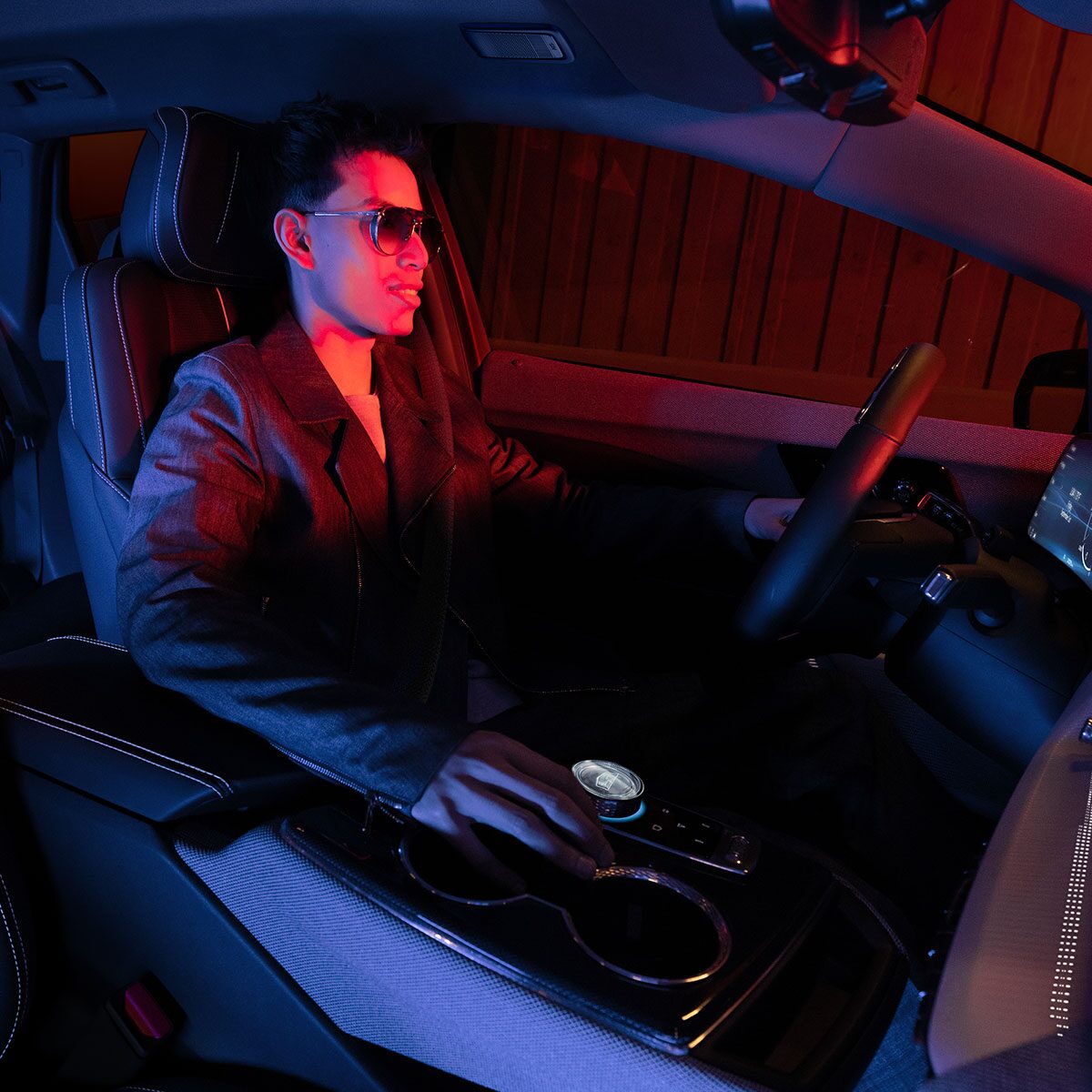 Passenger View of a Man Driving the 2025 Cadillac OPTIQ in a Red Light