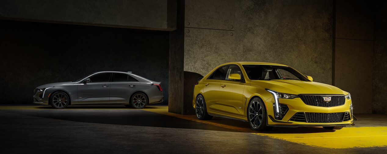 A Silver 2025 CT4-V and a Yellow 2025 CT4-V Blackwing Parked in a Parking Garage