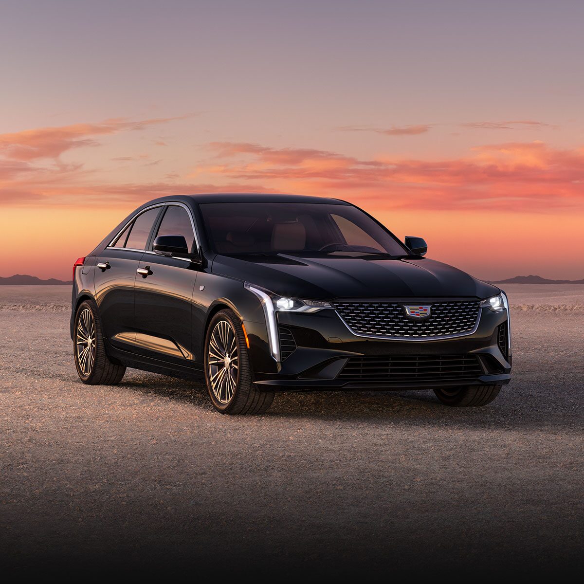Three Quarters Front View of a Black 2026 CT4 Parked in the Open Desert