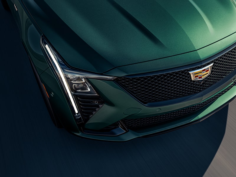 Close-up over the Top View of the Hood of the Green 2025 Cadillac CT5-V Shining in Sunlight