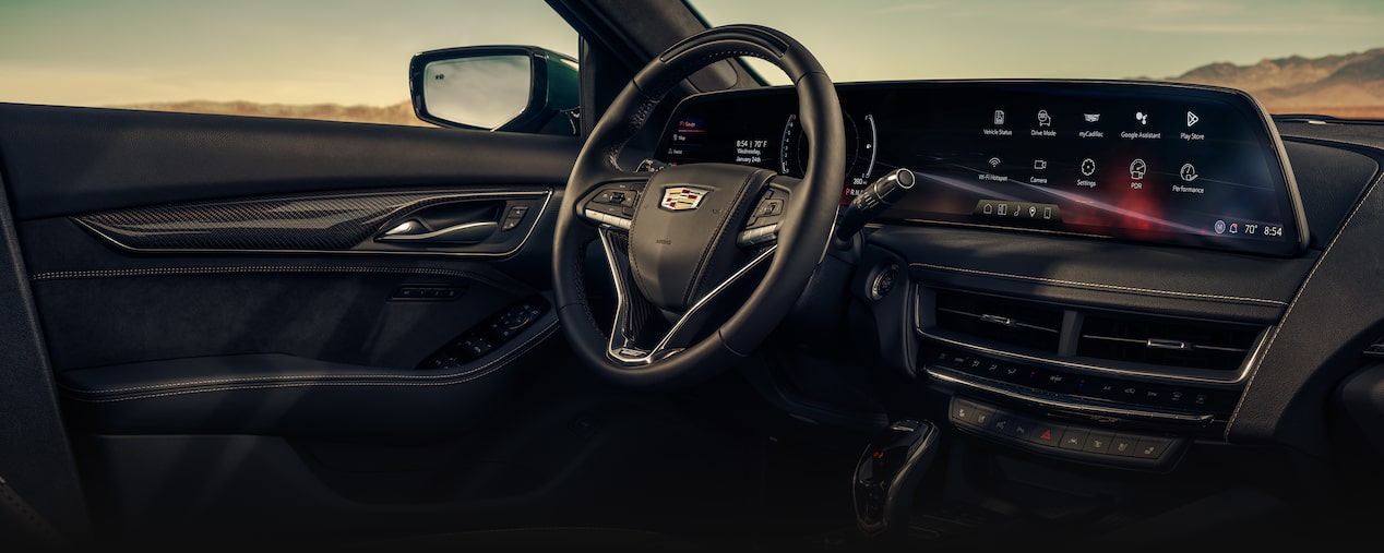 Front Passenger View of the 2025 Cadillac CT5-V Interior Steering Wheel and Dashboard under a Beautiful Sky