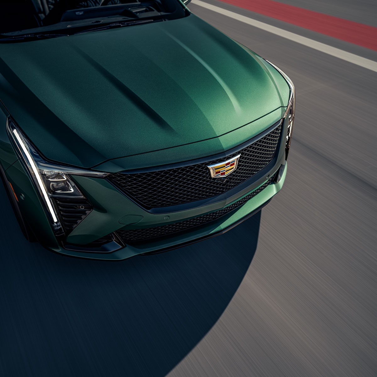 Close-up Over the Top View of the Hood of the Green 2025 Cadillac CT5-V Shining in Sunlight