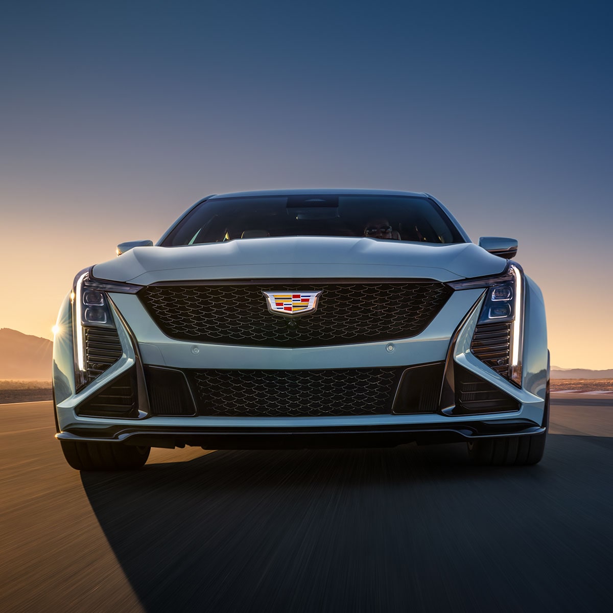 Low Front View of a Light Blue 2025 Cadillac CT5-V Driving Down the Road