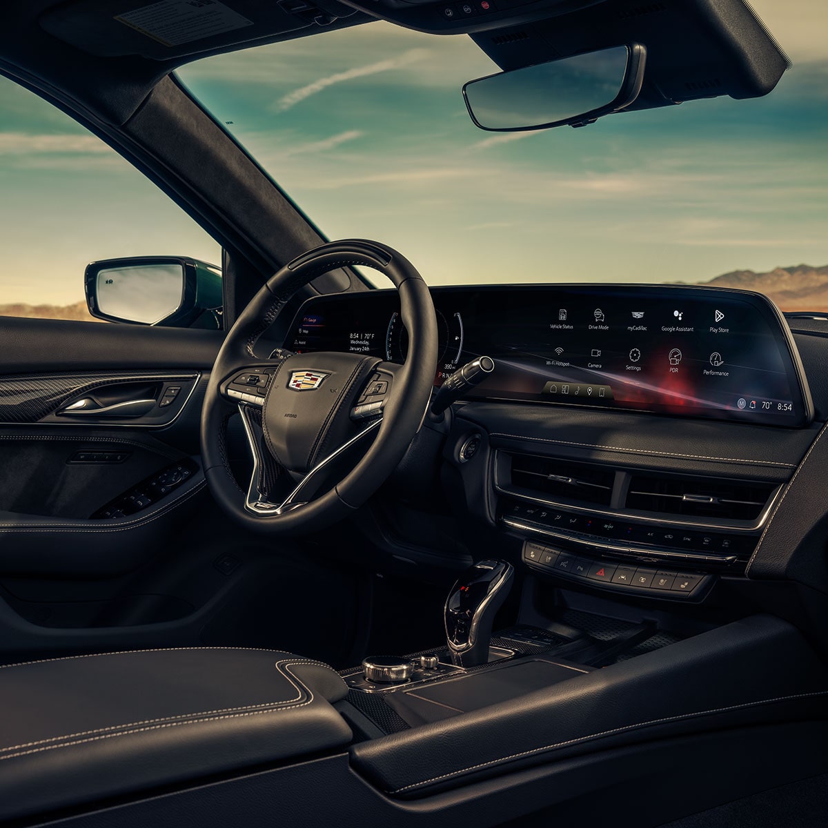 Front Passenger View of the 2025 Cadillac CT5-V Interior Steering Wheel and Dashboard under a Beautiful Sky