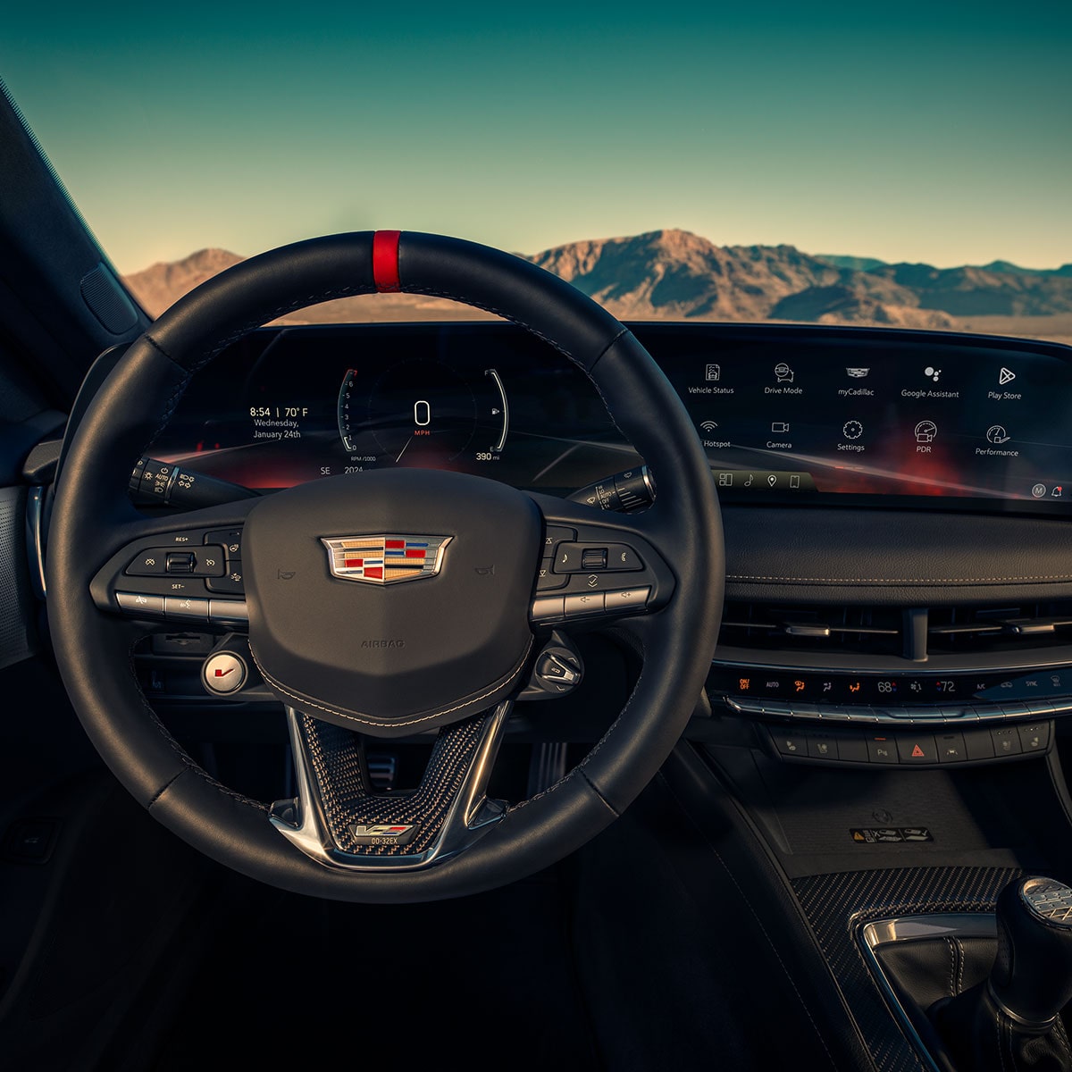 Driver's Seat View of a 2025 Cadillac CT5-V Steering Wheel and Dashboard in Front of Mountains