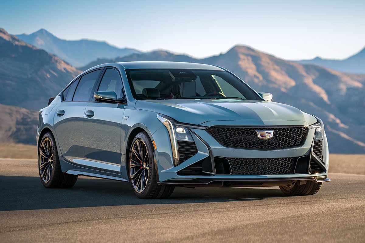 Three-Quarters View of a 2025 Silver 2025 Cadillac CT5-V in a Desert with Mountains Visible in the Distance