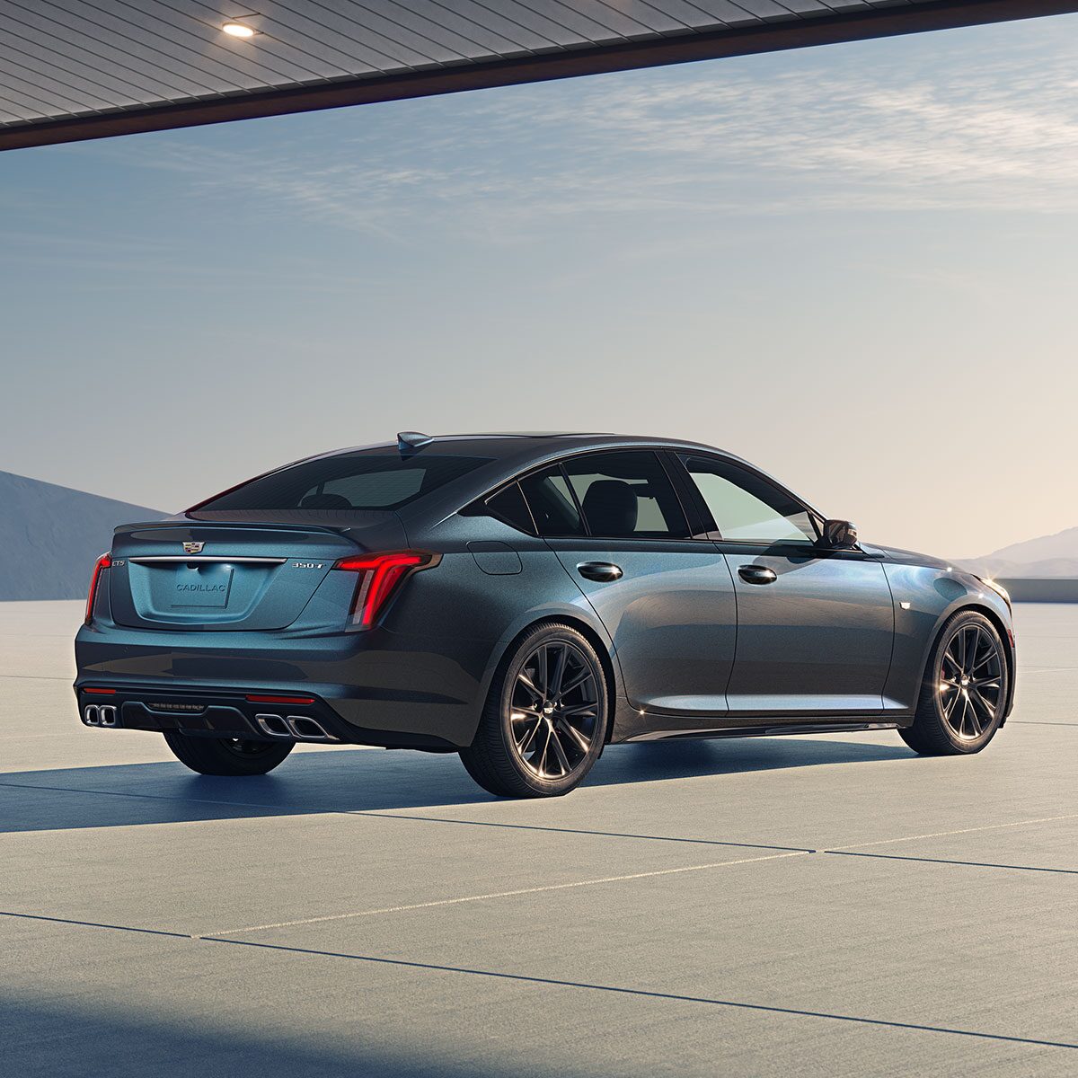 An Exterior Rear View of a Parked 2025 Cadillac CT5 Sport Outlooking the Blue Sky