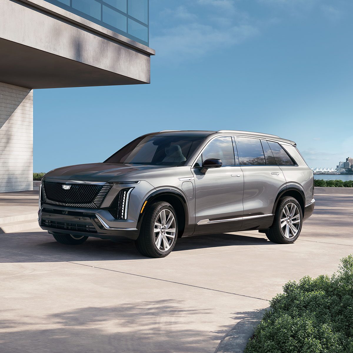 Three-quarters View of a 2026 VISTIQ 3-row Electric SUV Parked Near a Concrete Wall