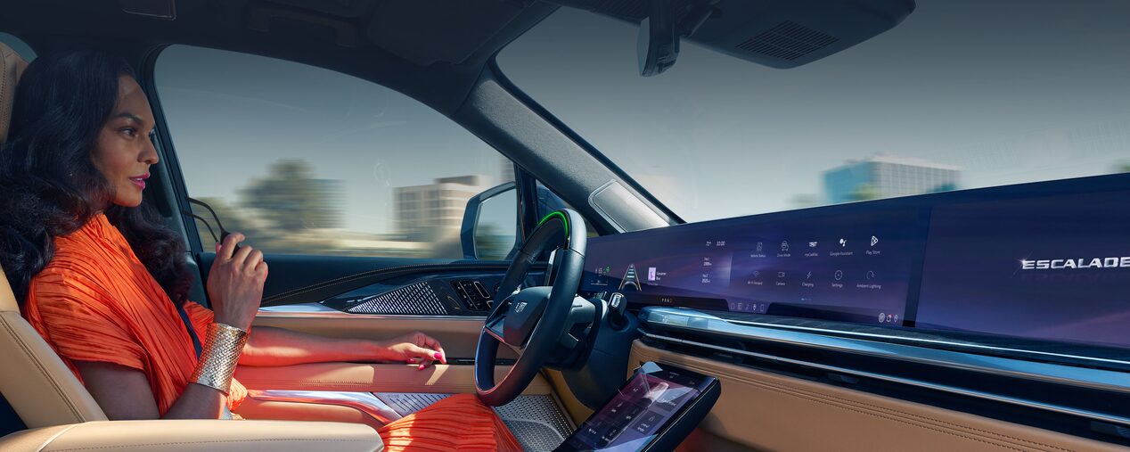 Passenger View of a Woman Driving a Cadillac with Hands Off the Steering Wheel and Utilizing the Super Cruise Feature