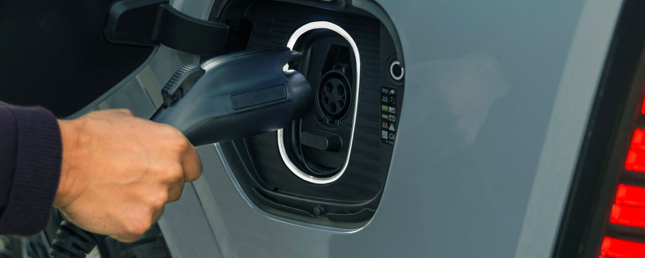 Close-up of Someone Inserting the EV Charger into the Port of a 2026 ESCALADE IQL