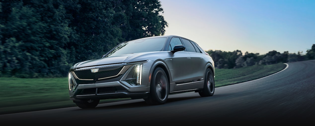 Three-Quarters View of the 2026 Cadillac LYRIQ-V Driving Down the Road