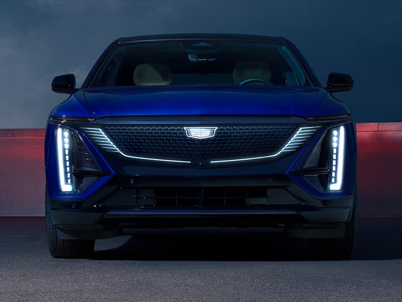 Front View of a Parked Blue Cadillac LYRIQ and Close-up on LED Slim Headlights